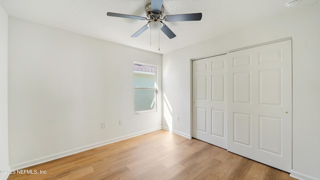 unfurnished bedroom featuring ceiling fan, a closet, and light hardwood / wood-style floors