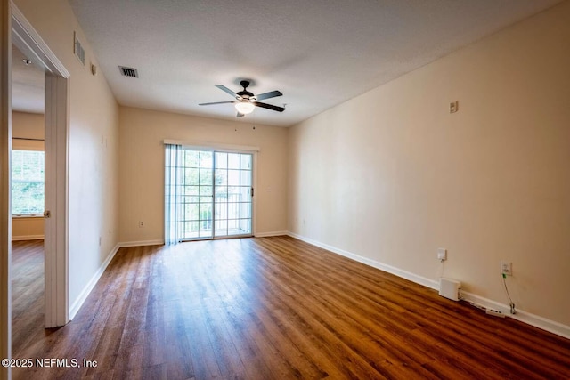 spare room featuring ceiling fan and dark hardwood / wood-style flooring