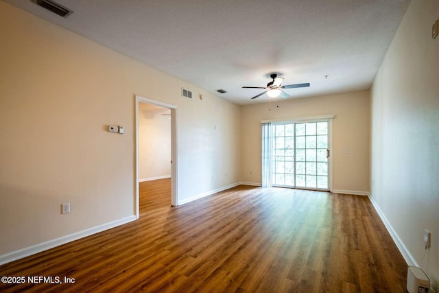 spare room featuring dark hardwood / wood-style flooring and ceiling fan