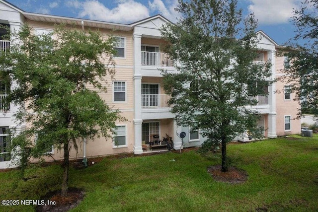 view of front of property with cooling unit and a front yard