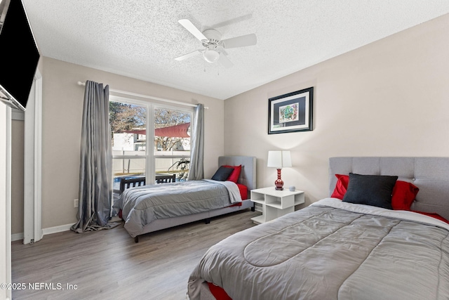 bedroom featuring ceiling fan, a textured ceiling, and light hardwood / wood-style floors