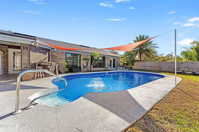 view of swimming pool featuring a grill and a patio