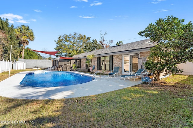 view of pool with a shed, a yard, and a patio