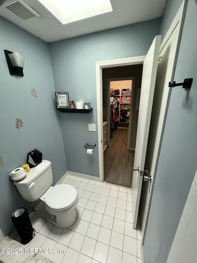 bathroom with toilet and tile patterned floors