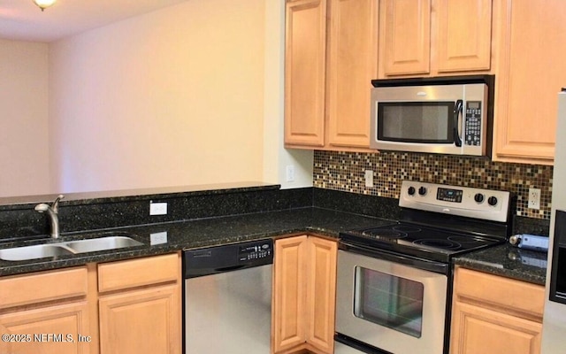 kitchen with light brown cabinetry, sink, and appliances with stainless steel finishes