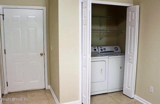 clothes washing area featuring light tile patterned floors and independent washer and dryer