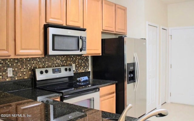 kitchen featuring tasteful backsplash, dark stone counters, and stainless steel appliances