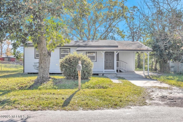 view of front facade with a front yard and a carport