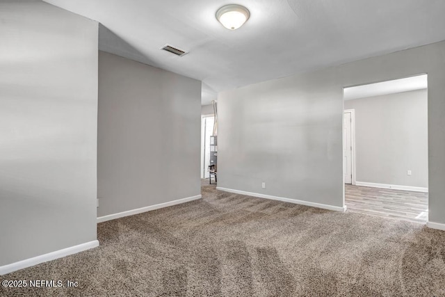 unfurnished room featuring carpet