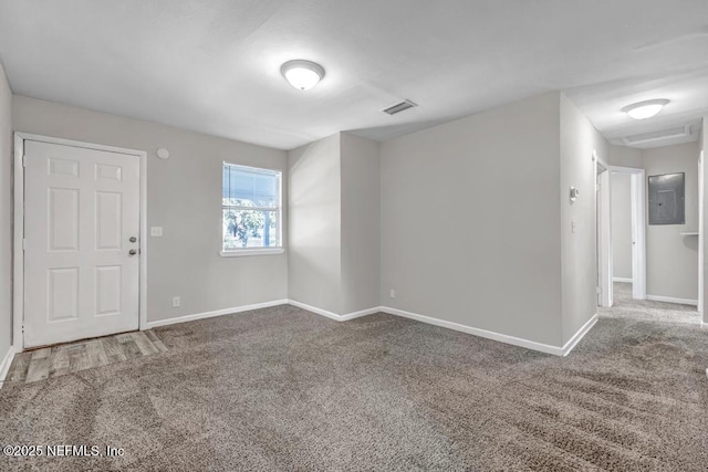 empty room featuring carpet flooring and electric panel