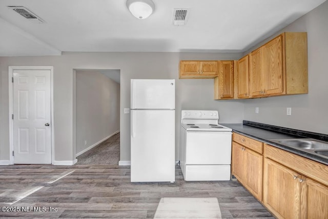 kitchen with sink, white appliances, and light wood-type flooring