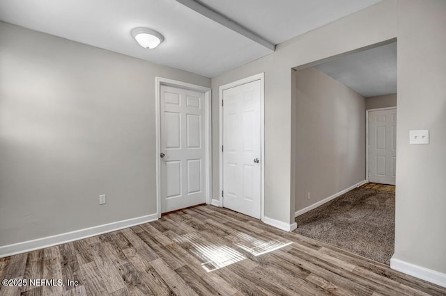 unfurnished room with wood-type flooring