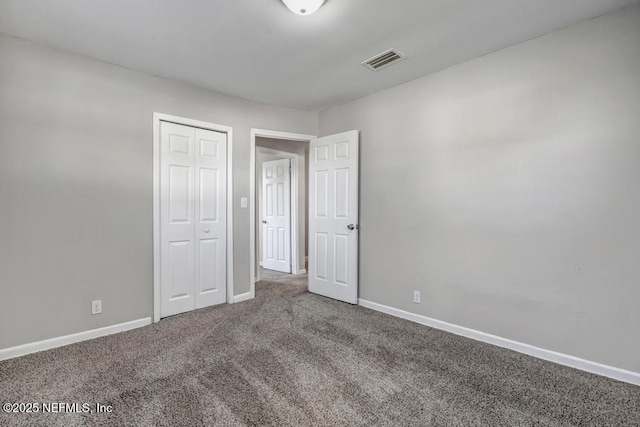 unfurnished bedroom with carpet floors and a closet