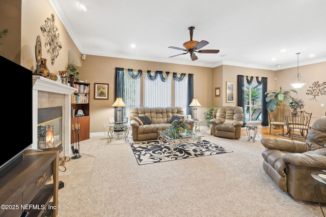 living room with light colored carpet, ornamental molding, a tile fireplace, and ceiling fan