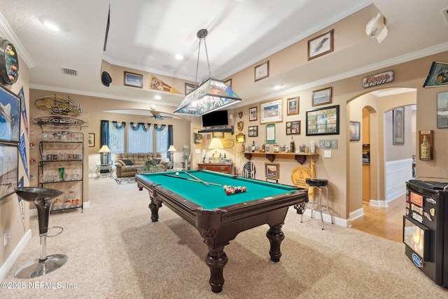 recreation room featuring ornamental molding, light carpet, bar area, and pool table