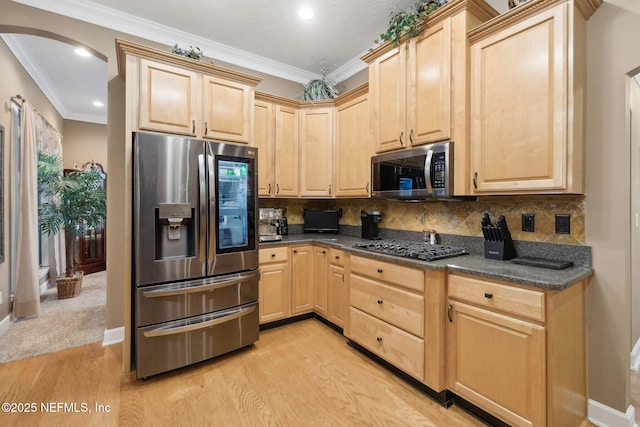 kitchen with light brown cabinetry, ornamental molding, and appliances with stainless steel finishes