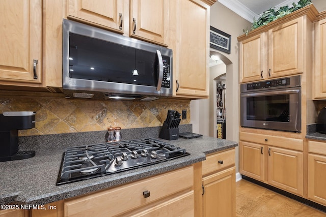 kitchen with crown molding, appliances with stainless steel finishes, backsplash, light hardwood / wood-style floors, and light brown cabinetry