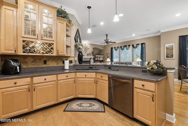 kitchen featuring stainless steel dishwasher, kitchen peninsula, sink, and light brown cabinets