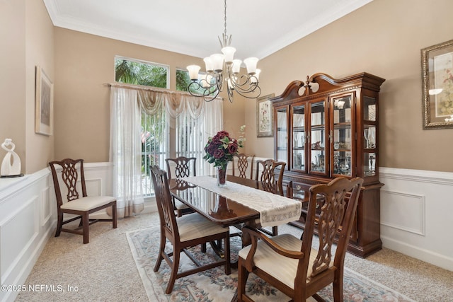 dining area with crown molding, light colored carpet, and a chandelier