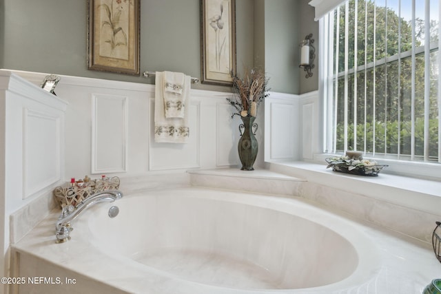 bathroom featuring a bathing tub and plenty of natural light