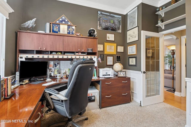 office space featuring crown molding, light carpet, french doors, and a high ceiling