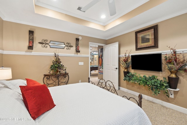 carpeted bedroom with a tray ceiling, ornamental molding, and ceiling fan