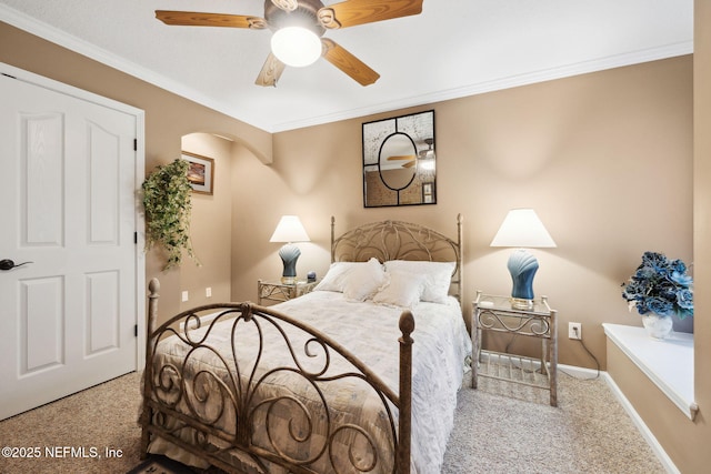 bedroom with crown molding, light colored carpet, and ceiling fan