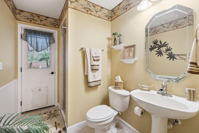 bathroom with sink, tile patterned floors, and toilet