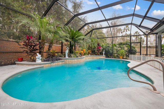 view of swimming pool with pool water feature, a lanai, and a patio