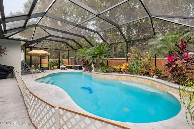 view of pool with a patio and glass enclosure