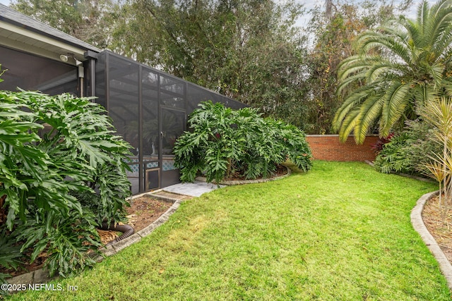 view of yard with glass enclosure