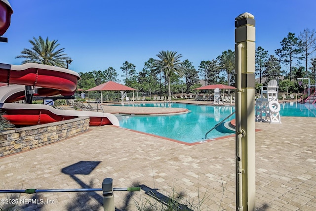 view of pool with a gazebo, a water slide, and a patio area