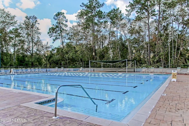 view of pool featuring tennis court