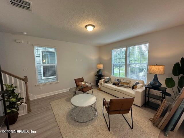 living room featuring hardwood / wood-style floors and a textured ceiling