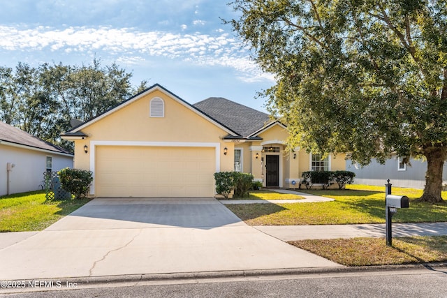 view of front of property featuring a garage and a front yard