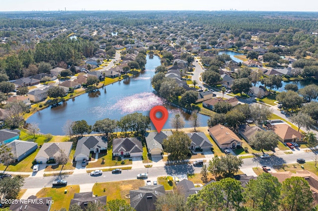 birds eye view of property with a water view and a residential view