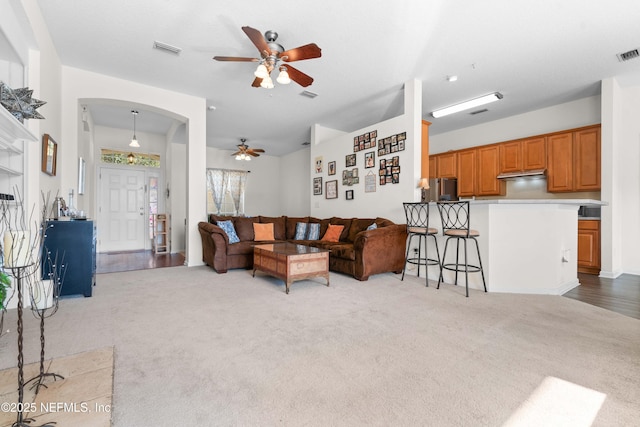 living area with light carpet and visible vents