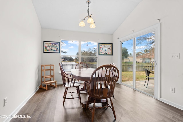 dining space with lofted ceiling, plenty of natural light, and wood finished floors