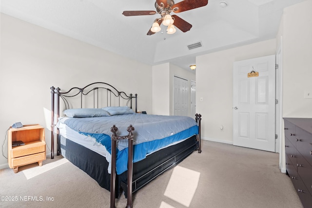 bedroom with baseboards, visible vents, a ceiling fan, light colored carpet, and a closet