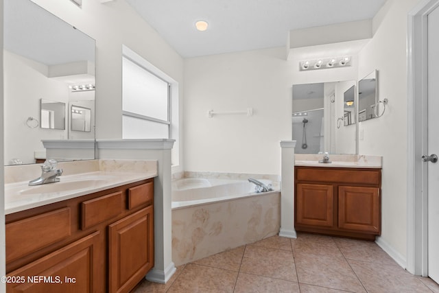 bathroom featuring a stall shower, a garden tub, a sink, and tile patterned floors