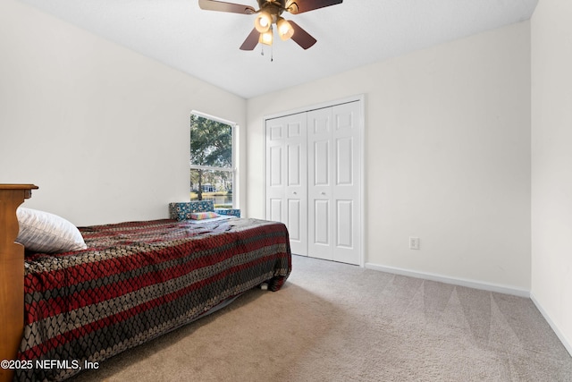 bedroom featuring a ceiling fan, carpet, a closet, and baseboards