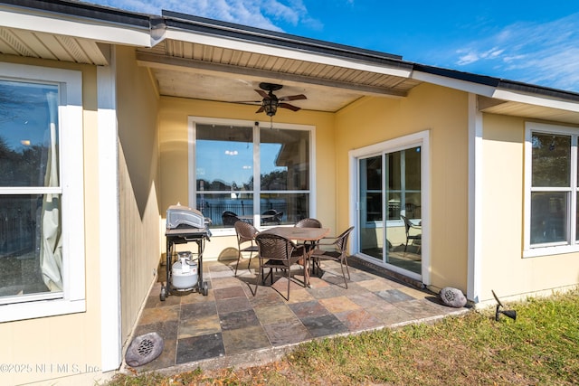 view of patio / terrace with a ceiling fan, outdoor dining space, and a grill