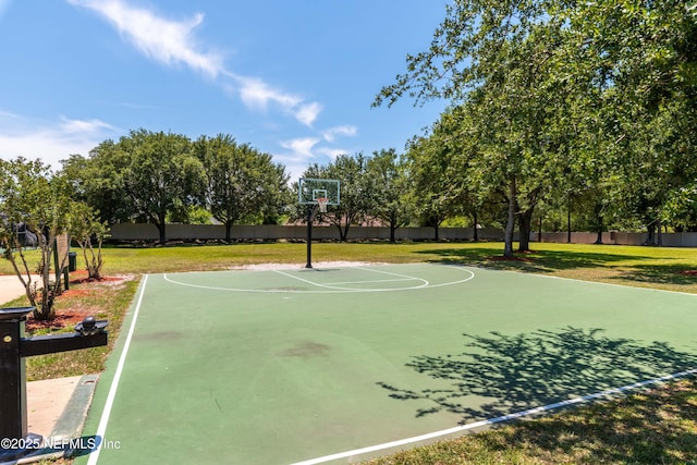 view of basketball court with community basketball court, a yard, and fence