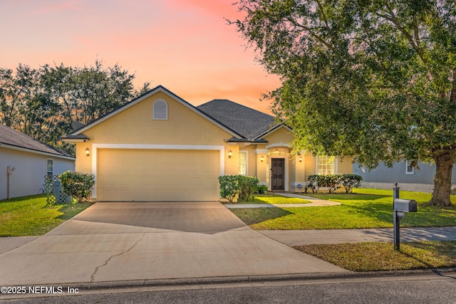 view of front of house with a front yard, roof with shingles, driveway, stucco siding, and a garage
