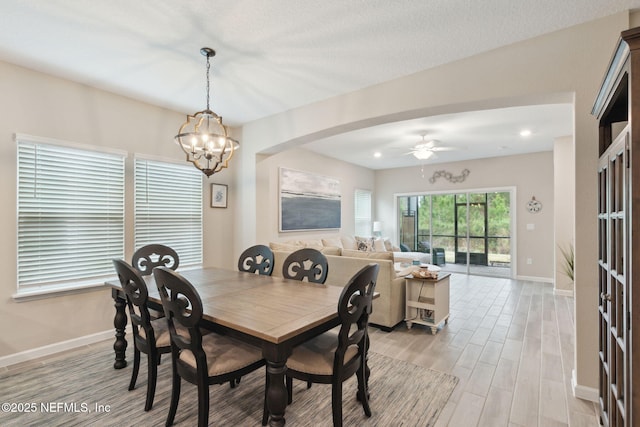 dining area featuring ceiling fan with notable chandelier, recessed lighting, light wood-style flooring, and baseboards