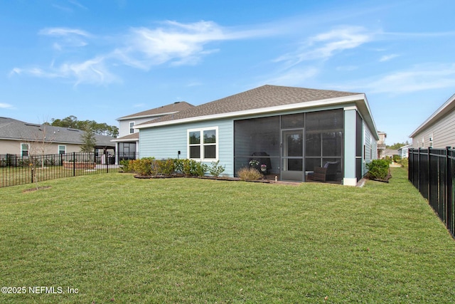 rear view of house with a sunroom, a fenced backyard, and a lawn