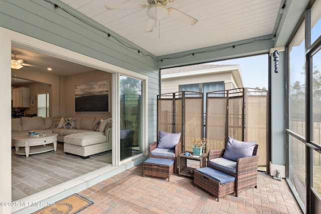 sunroom featuring ceiling fan