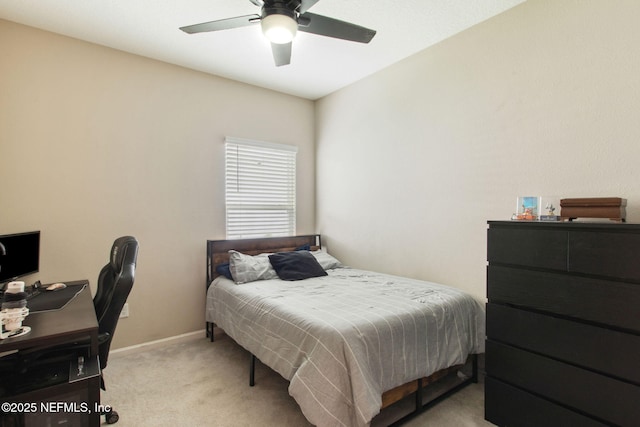 bedroom with a ceiling fan, light carpet, and baseboards