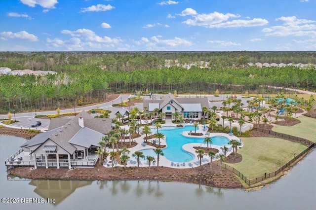 birds eye view of property with a water view and a wooded view