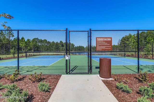 view of sport court featuring a gate and fence